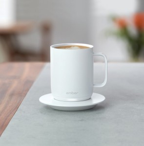 Ember 14 Oz. Smart Mug in White in an outdoor environment on a table
