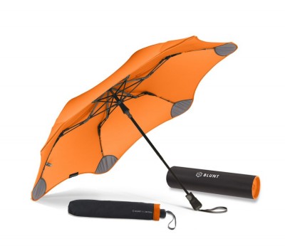 Blunt Metro Umbrella shown in Orange and open next to its carrying pouch and box