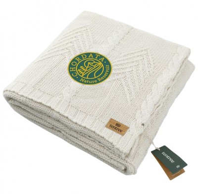 Tentree Cable Blanket in white and folded with an example logo embroidered on it