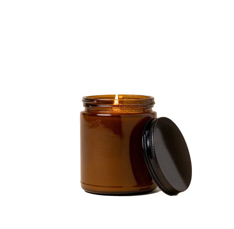 Glass Jar Candle shown lit with its lid to the side