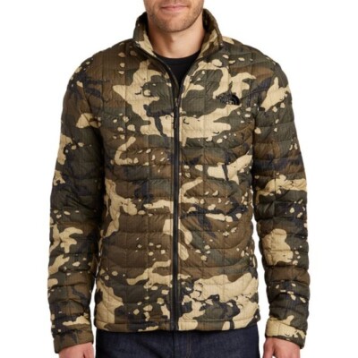 The North Face Unisex ThermoBall Trekker Jacket shown on a male model in the color: Burnt Olive Green Woodchip Camp Print
