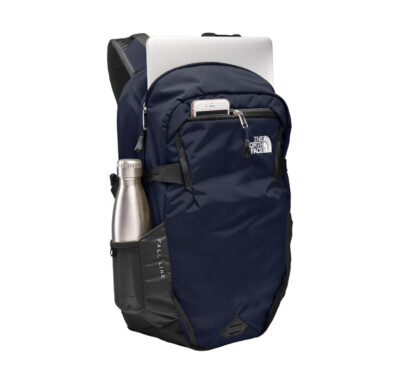 The North Face Fall Backpack shown in Cosmic Blue with items inside the pockets
