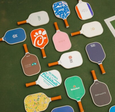 A variety of Recess Pickleball Paddles shown with different example logos and designs