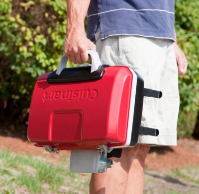 Cuisinart Portable Gas Grill shown in Red being held by a person