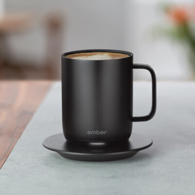  Ember 14 Oz. Smart Mug in Black shown in an outdoor environment